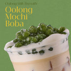 Oolong milk tea with oolong mochi boba on a green background