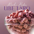 Glass bowl filled with pink Ube Taro mochi boba on a pink background